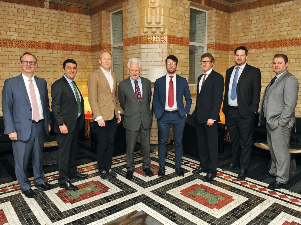 Group photo of the fixed income roundtable attendees inside the art deco venue.